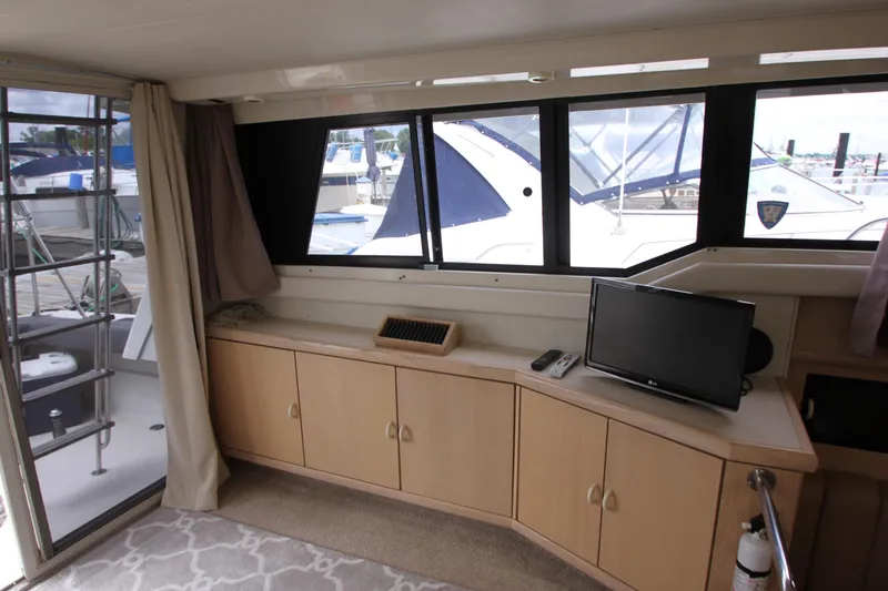 Slide: The Image of Interior of 1990 Silverton 34 Convertible yacht with TV and cabinets. - 14