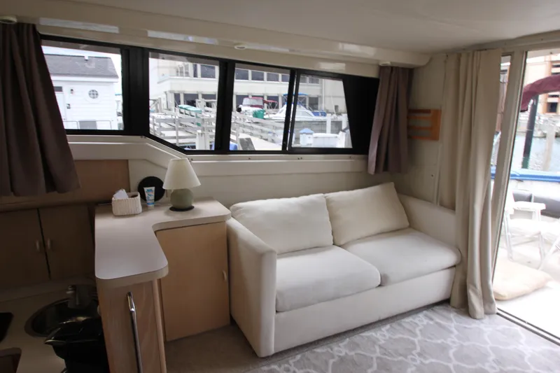 Slide: The Image of Interior of 1990 Silverton 34 Convertible yacht with sofa and windows. - 15