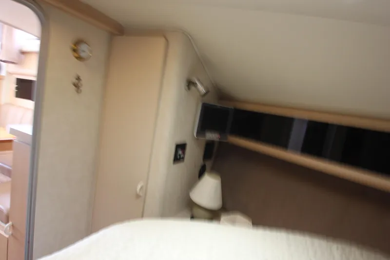 Slide: The Image of Interior cabin of 1990 Silverton 34 Convertible boat, featuring cozy sleeping area. - 23