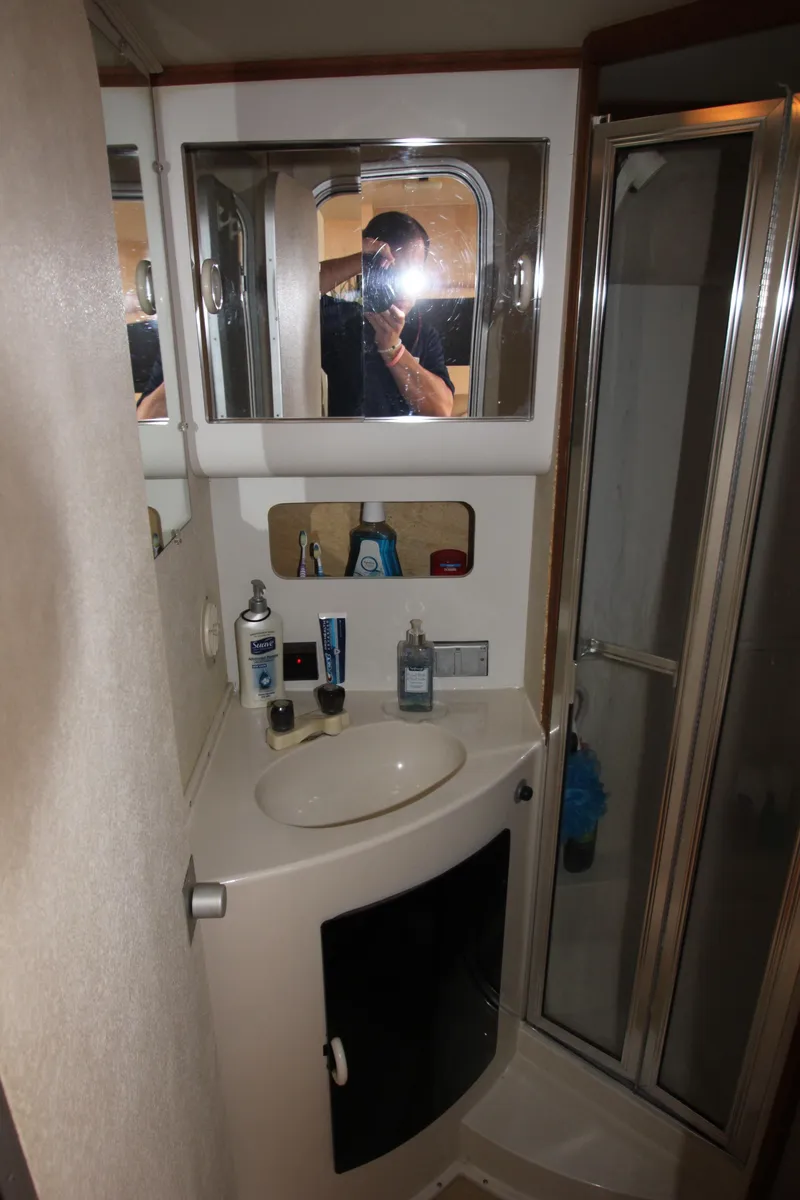 Slide: The Image of 1990 Silverton 34 Convertible bathroom with sink, mirror, and shower. - 25