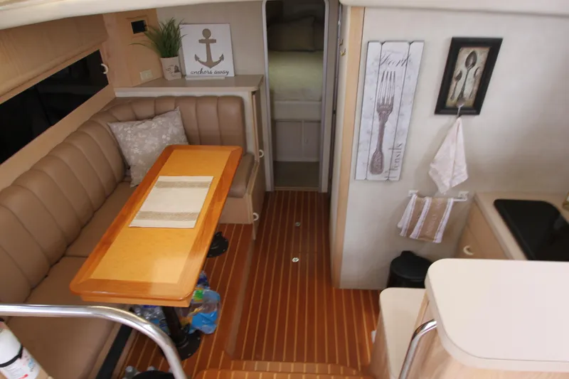 Slide: The Image of Interior of 1990 Silverton 34 Convertible yacht with dining area and kitchen. - 33