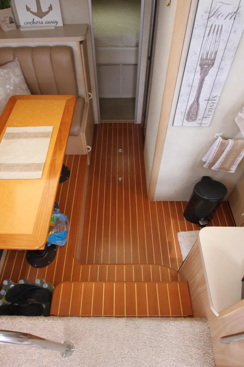 Slide: The Image of Interior of 1990 Silverton 34 Convertible yacht with wooden flooring and dining area. - 34
