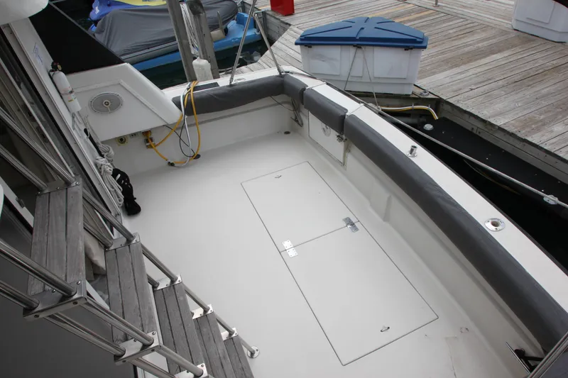 Slide: The Image of 1990 Silverton 34 Convertible boat deck with seating and dock view. - 37