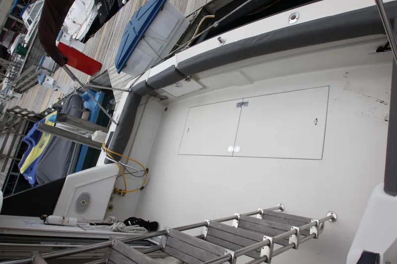 Slide: The Image of 1990 Silverton 34 Convertible boat deck with ladder and docked surroundings. - 38