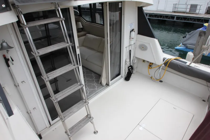 Slide: The Image of 1990 Silverton 34 Convertible boat interior with ladder and dock view. - 39