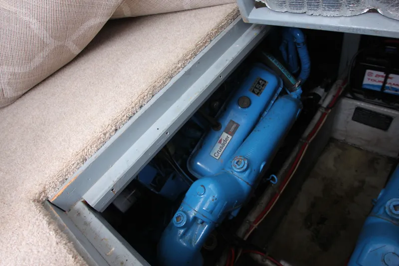 Slide: The Image of Engine compartment of a 1990 Silverton 34 Convertible boat, featuring a blue engine. - 40