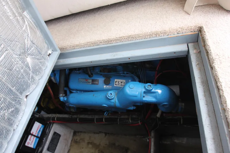 Slide: The Image of Engine compartment of 1990 Silverton 34 Convertible boat, featuring a blue marine engine. - 41