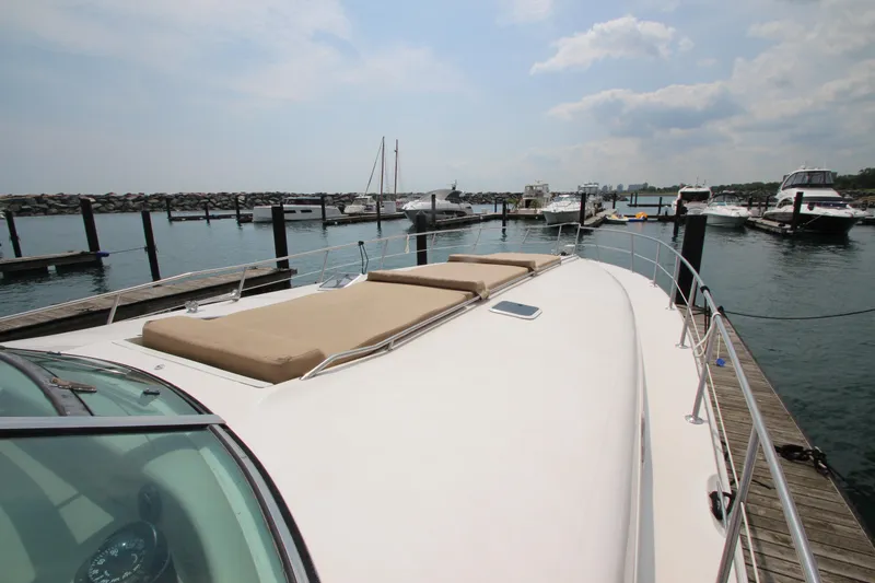 Slide: The Image of 1998 Sea Ray 500 Sundancer yacht docked at marina with sun pads. - 10
