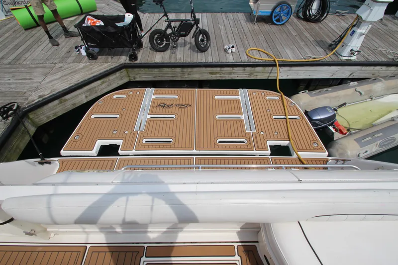 Slide: The Image of 1998 Sea Ray 500 Sundancer swim platform at dock with accessories. - 12