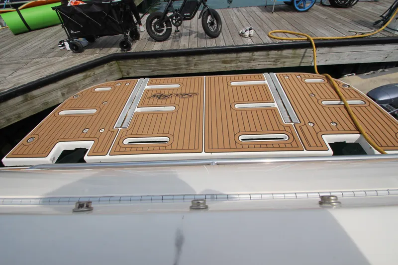 Slide: The Image of 1998 Sea Ray 500 Sundancer swim platform at dock with wooden deck. - 14