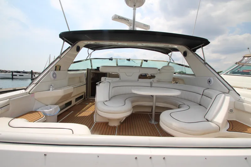 Slide: The Image of 1998 Sea Ray 500 Sundancer yacht with spacious seating area and wooden deck. - 15