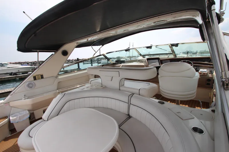 Slide: The Image of 1998 Sea Ray 500 Sundancer yacht interior with white leather seating and helm station. - 17