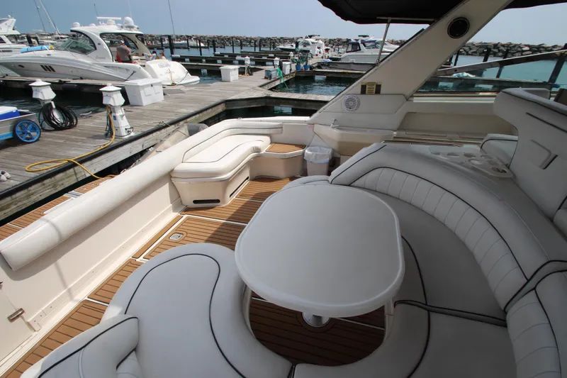 Slide: The Image of 1998 Sea Ray 500 Sundancer yacht interior with white seating and table at marina. - 18