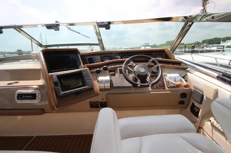 Slide: The Image of 1998 Sea Ray 500 Sundancer helm with navigation equipment and leather seating. - 24