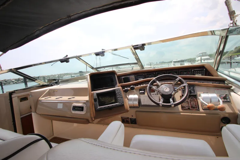 Slide: The Image of 1998 Sea Ray 500 Sundancer helm with steering wheel and navigation equipment. - 25