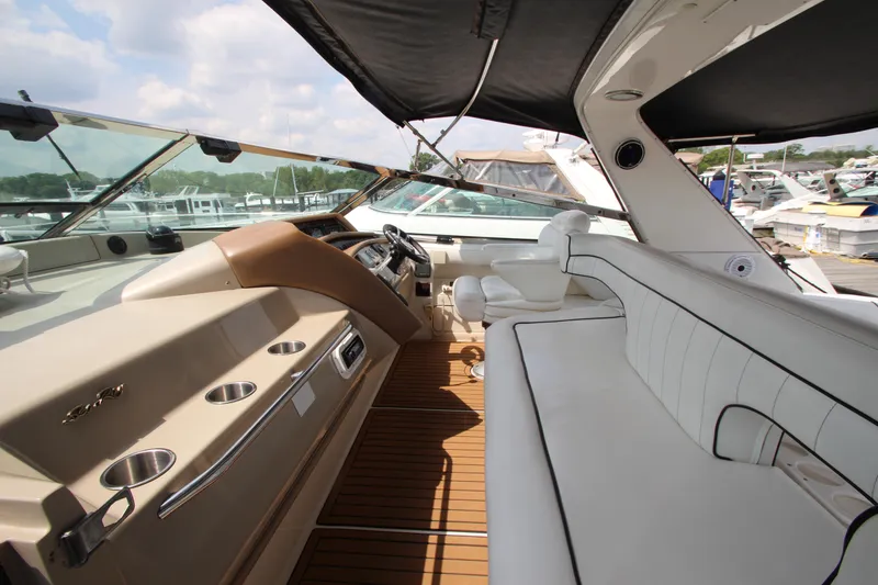 Slide: The Image of 1998 Sea Ray 500 Sundancer yacht interior with white seating and wooden flooring. - 26