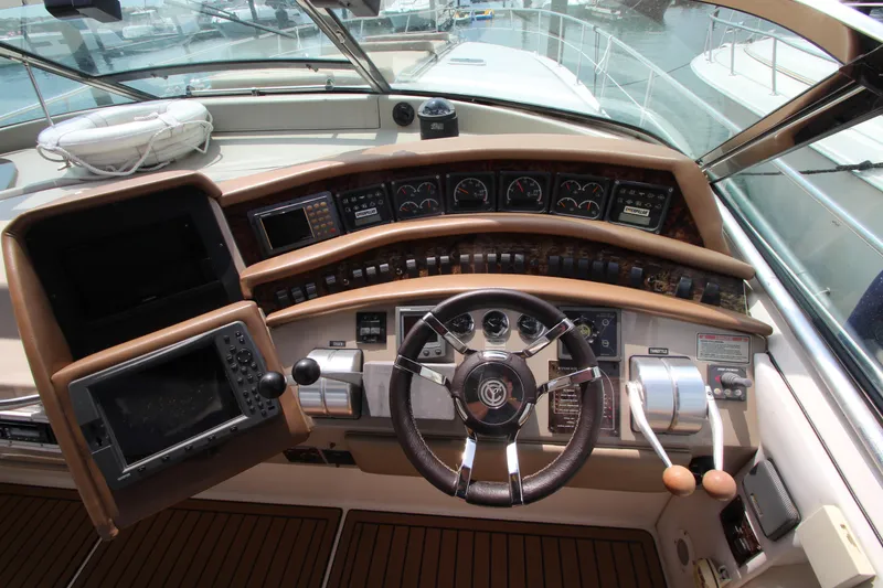 Slide: The Image of 1998 Sea Ray 500 Sundancer helm with navigation instruments and steering wheel. - 29