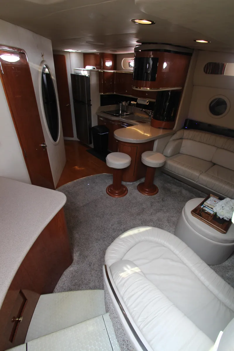 Slide: The Image of Interior of 1998 Sea Ray 500 Sundancer yacht with modern kitchen and seating area. - 33