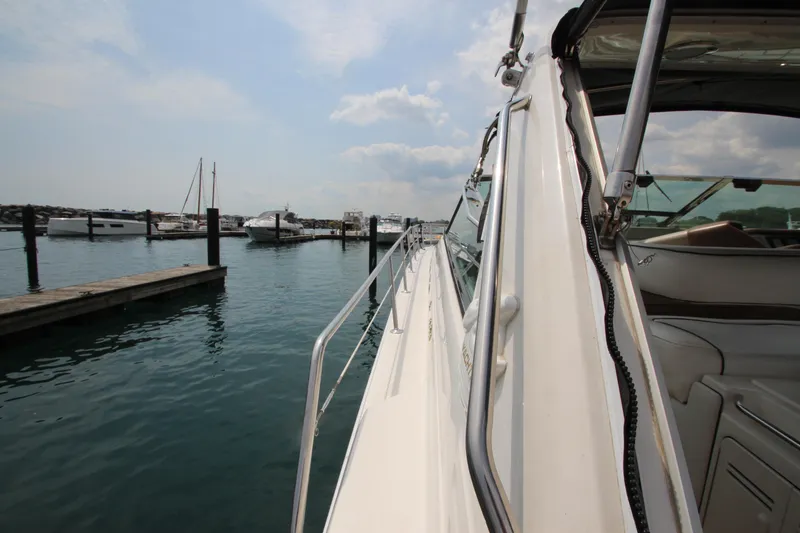 Slide: The Image of 1998 Sea Ray 500 Sundancer yacht docked at a marina on a sunny day. - 4