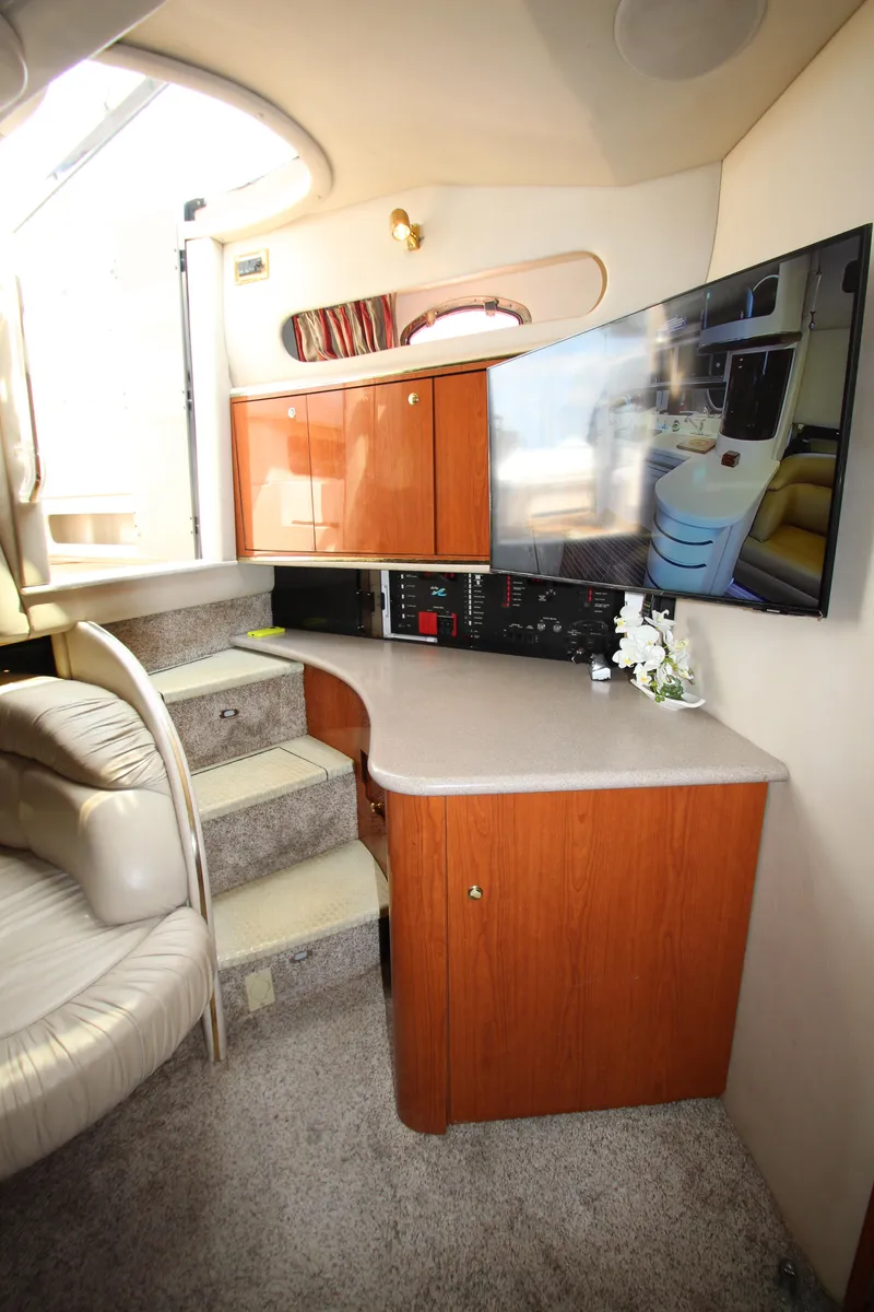 Slide: The Image of 1998 Sea Ray 500 Sundancer interior with stairs, cabinets, and mounted TV. - 40