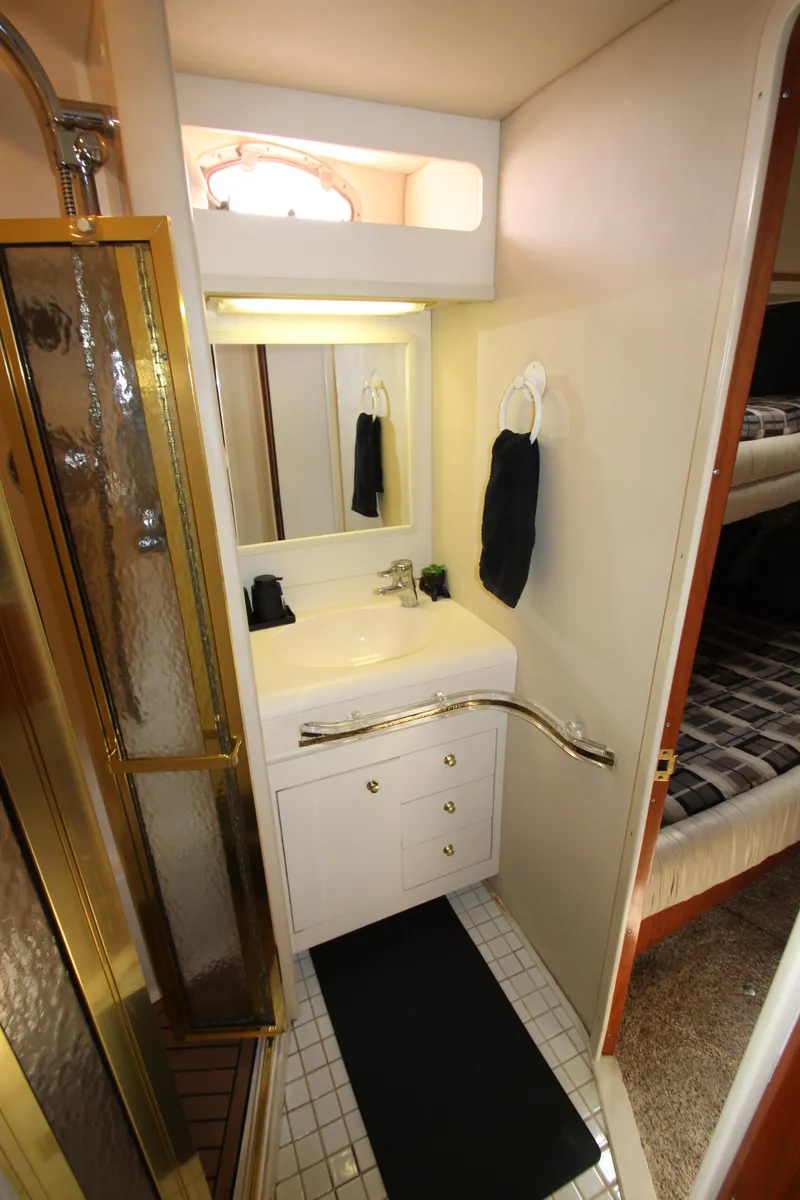 Slide: The Image of 1998 Sea Ray 500 Sundancer bathroom with shower, sink, and storage. - 44