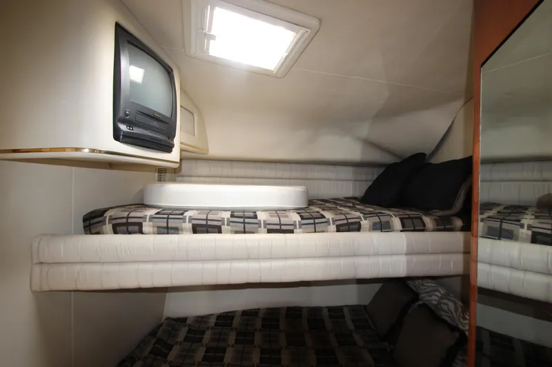 Slide: The Image of 1998 Sea Ray 500 Sundancer cabin with bunk beds and TV. - 48