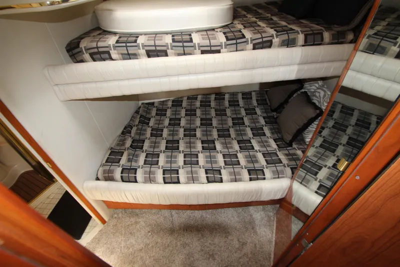 Slide: The Image of Bunk beds in the 1998 Sea Ray 500 Sundancer cabin with patterned bedding. - 49