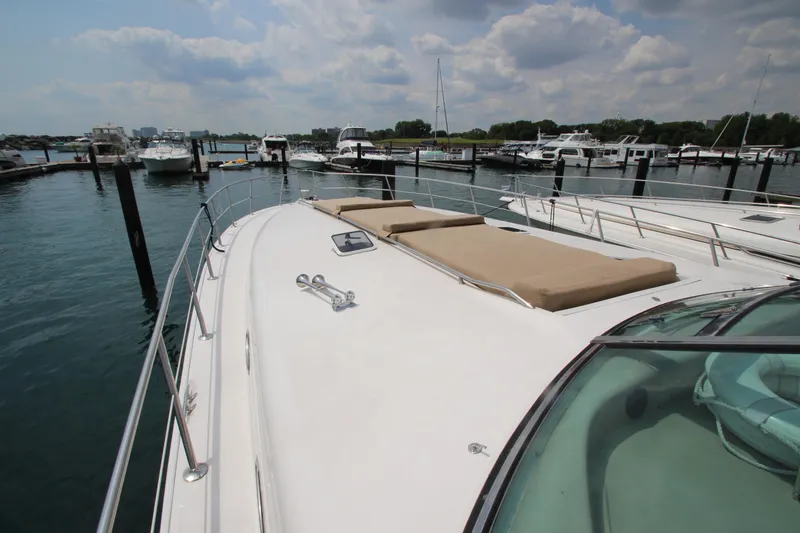 Slide: The Image of 1998 Sea Ray 500 Sundancer yacht docked at marina with sun pads on deck. - 5