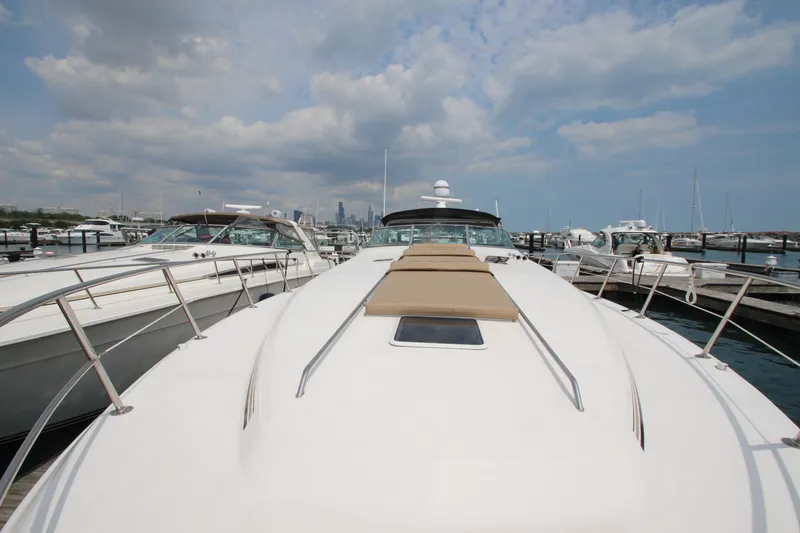 Slide: The Image of 1998 Sea Ray 500 Sundancer yacht docked at marina under cloudy sky. - 9