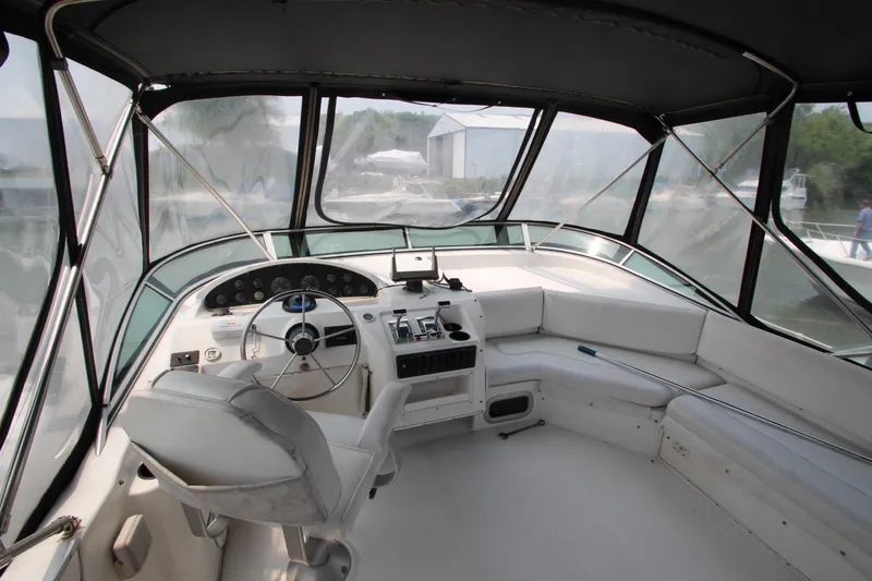 Slide: The Image of 1996 Bayliner 3988 Command Bridge Motoryacht helm with seating and navigation controls. - 12