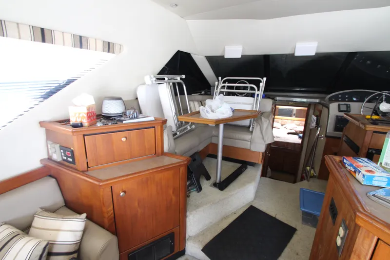 Slide: The Image of Interior of 1996 Bayliner 3988 Command Bridge Motoryacht with wooden cabinetry and seating area. - 19