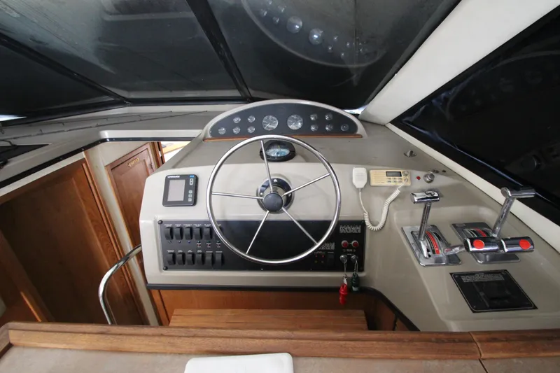 Slide: The Image of Helm of 1996 Bayliner 3988 Command Bridge Motoryacht with steering wheel and controls. - 23