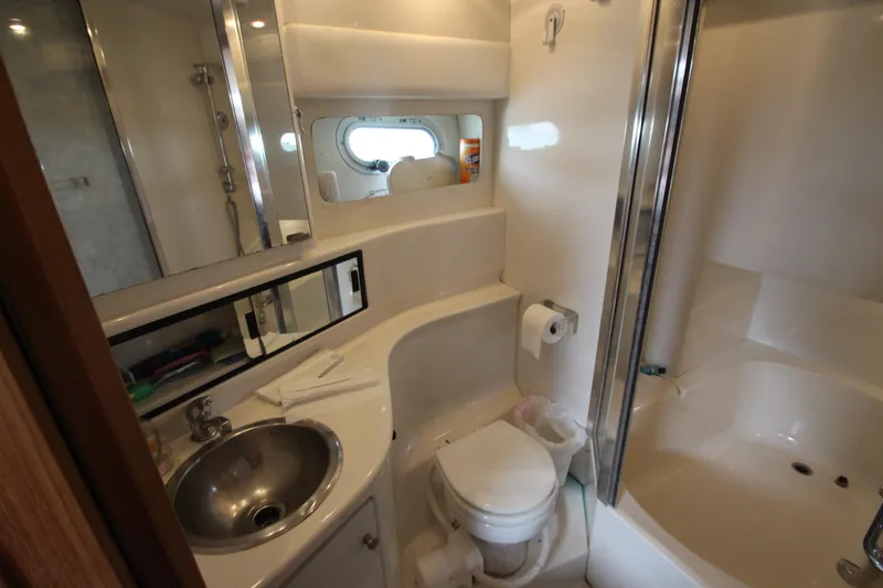 Slide: The Image of Bathroom interior of 1996 Bayliner 3988 Command Bridge Motoryacht, featuring sink, toilet, and shower. - 28