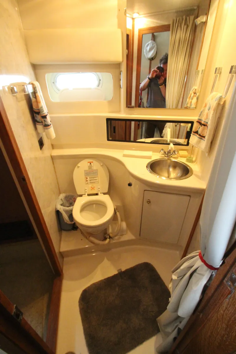 Slide: The Image of Bathroom interior of 1996 Bayliner 3988 Command Bridge Motoryacht, featuring sink and toilet. - 29