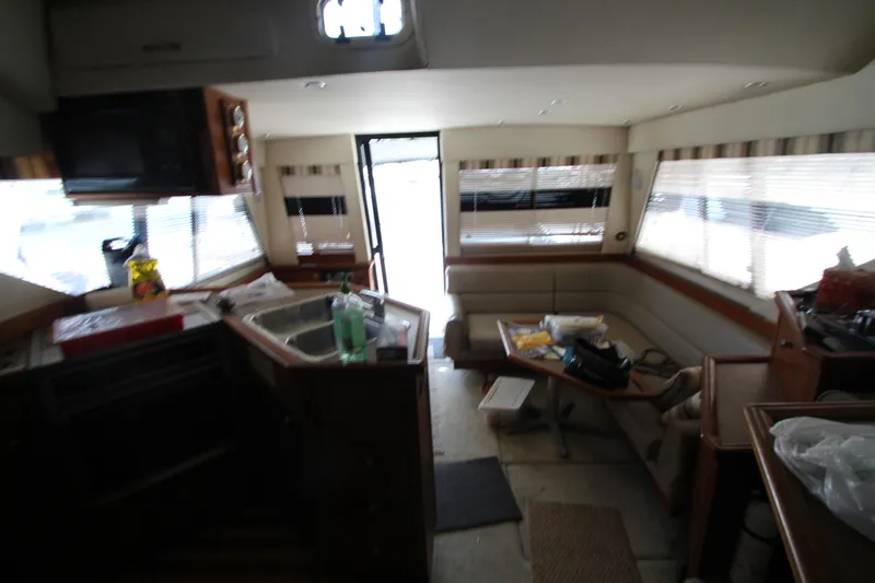 Slide: The Image of Interior of 1996 Bayliner 3988 Command Bridge Motoryacht with kitchen and seating area. - 35