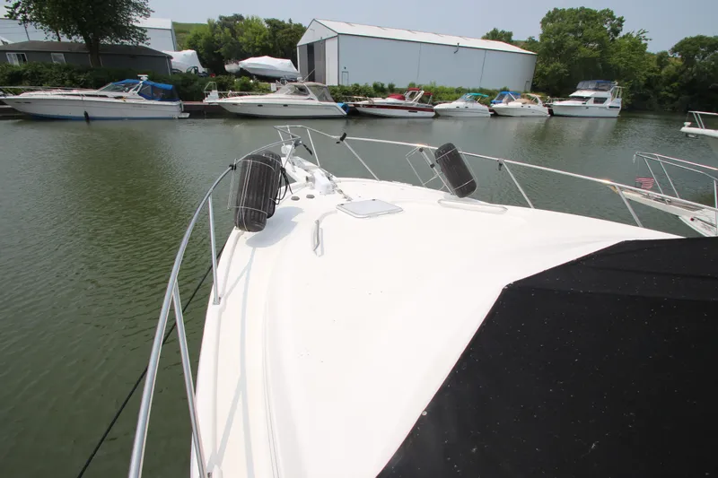 Slide: The Image of 1996 Bayliner 3988 Command Bridge Motoryacht docked in a marina with other boats. - 5