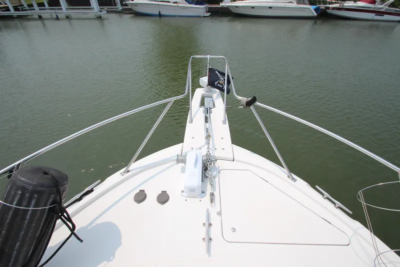 Slide: The Image of Bow view of 1996 Bayliner 3988 Command Bridge Motoryacht docked in marina. - 6