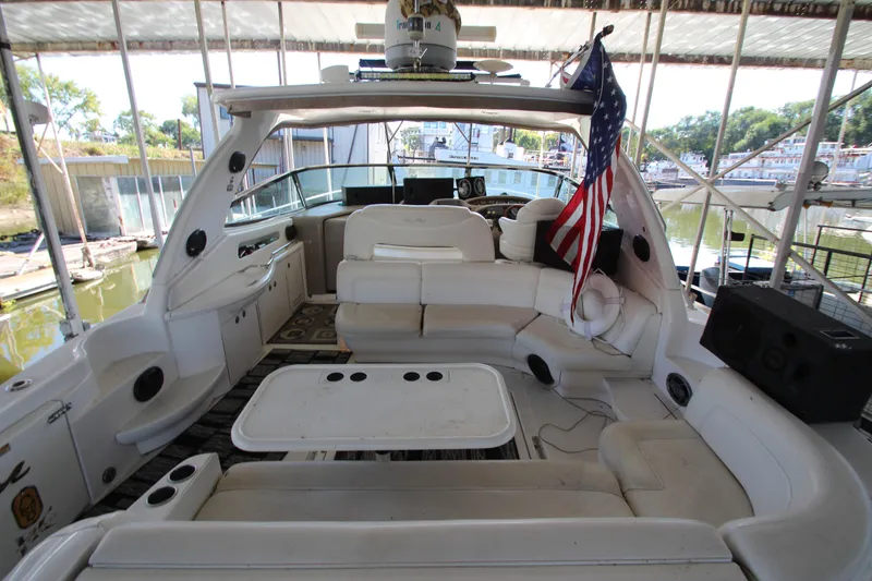 Slide: The Image of 2001 Sea Ray 460 Sundancer yacht interior with seating and American flag. - 10
