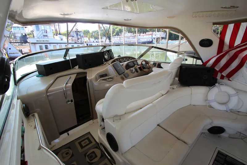 Slide: The Image of Interior of 2001 Sea Ray 460 Sundancer yacht with helm and seating area. - 11