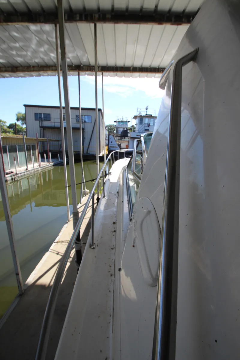 Slide: The Image of 2001 Sea Ray 460 Sundancer docked in marina, side view. - 13