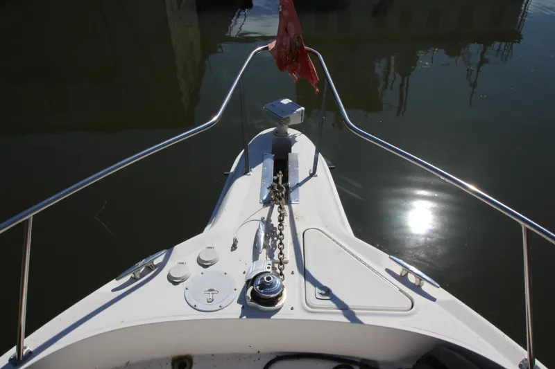 Slide: The Image of Bow view of 2001 Sea Ray 460 Sundancer yacht with anchor chain and calm water. - 15