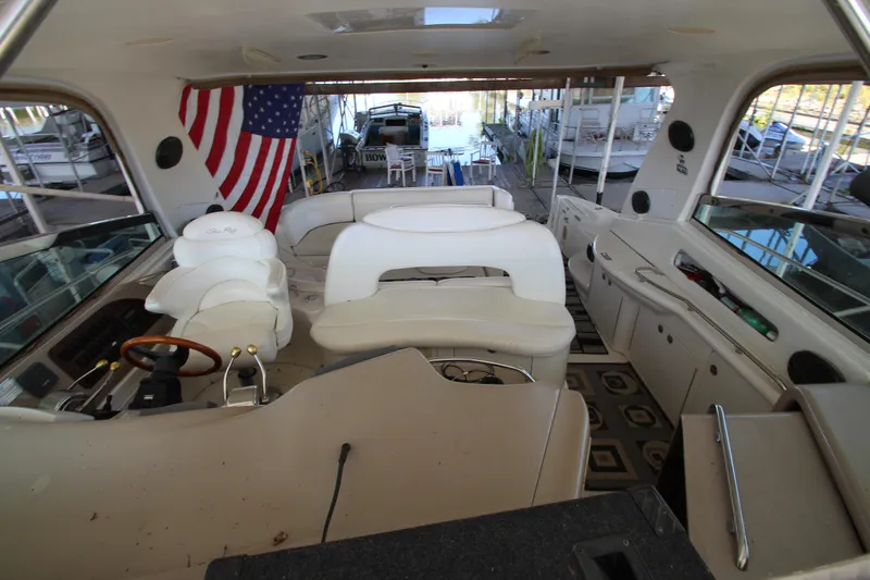 Slide: The Image of Interior of 2001 Sea Ray 460 Sundancer yacht with American flag and seating area. - 17