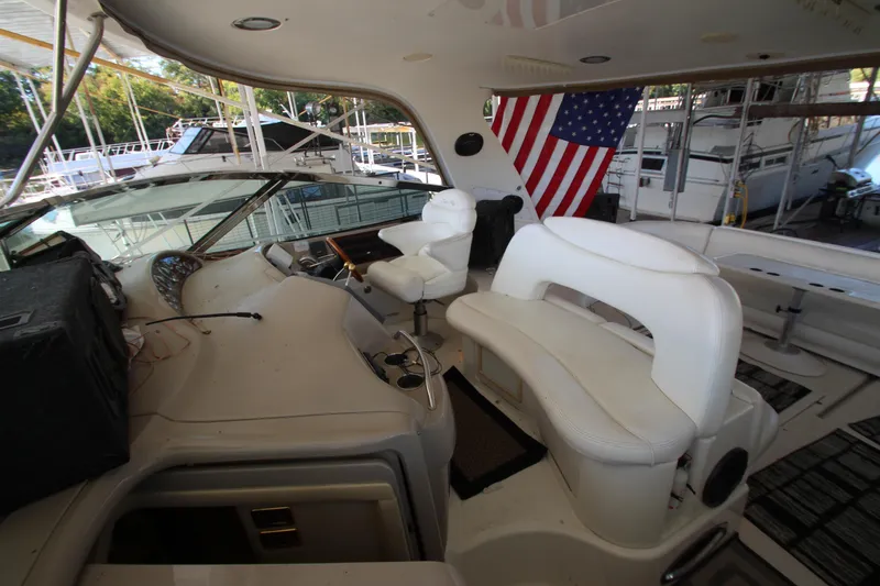 Slide: The Image of Interior of 2001 Sea Ray 460 Sundancer yacht with white seating and American flag. - 18