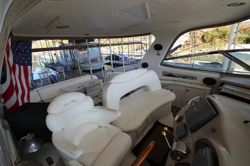 Slide: The Image of Interior of 2001 Sea Ray 460 Sundancer yacht with white seating and American flag. - 21
