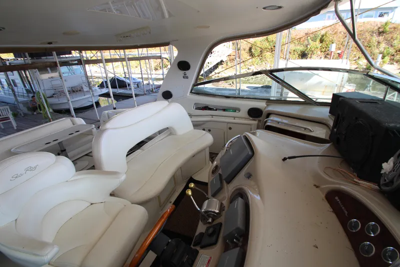 Slide: The Image of Interior view of 2001 Sea Ray 460 Sundancer yacht with white seating and control panel. - 22