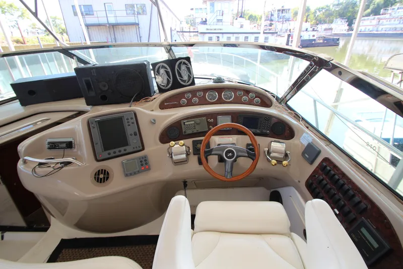 Slide: The Image of Helm of 2001 Sea Ray 460 Sundancer yacht with navigation instruments and steering wheel. - 23