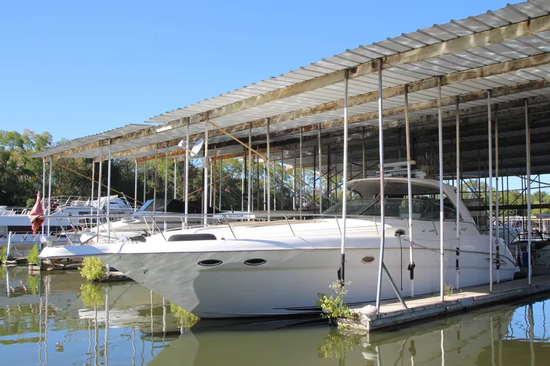 Slide: The Image of 2001 Sea Ray 460 Sundancer yacht docked in a covered marina. - 3