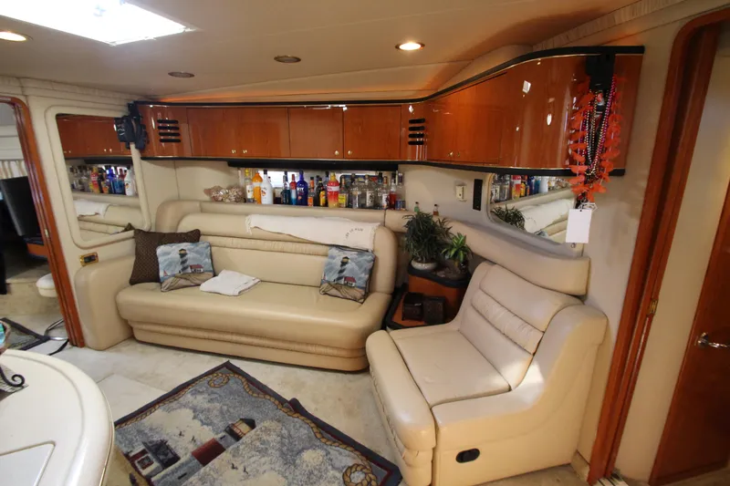 Slide: The Image of Luxurious interior of 2001 Sea Ray 460 Sundancer yacht with leather seating and bar area. - 32