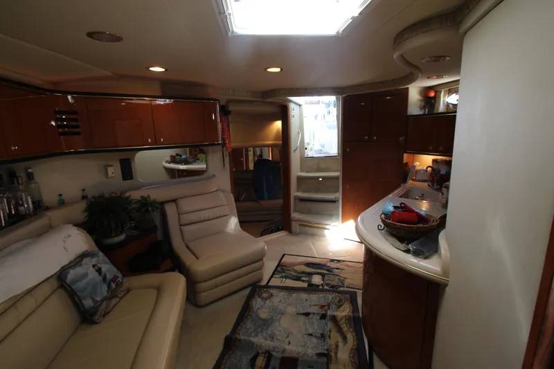 Slide: The Image of Interior of 2001 Sea Ray 460 Sundancer yacht with luxurious seating and modern amenities. - 34