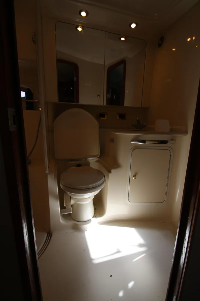Slide: The Image of Bathroom interior of 2001 Sea Ray 460 Sundancer yacht, featuring toilet and vanity. - 37